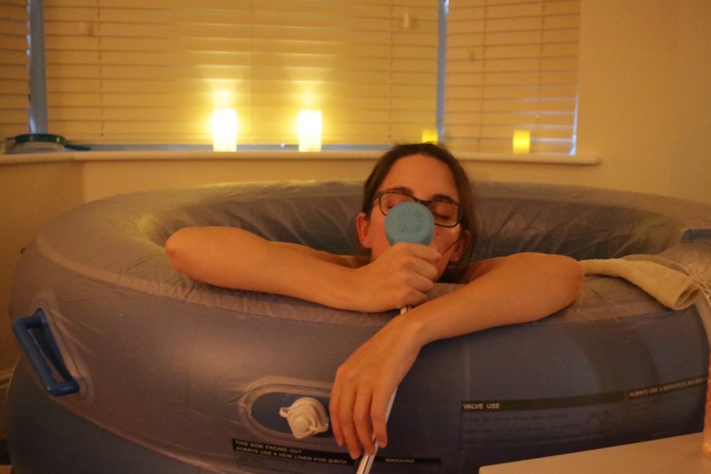 Me in the birth pool with gas and air - home birth story