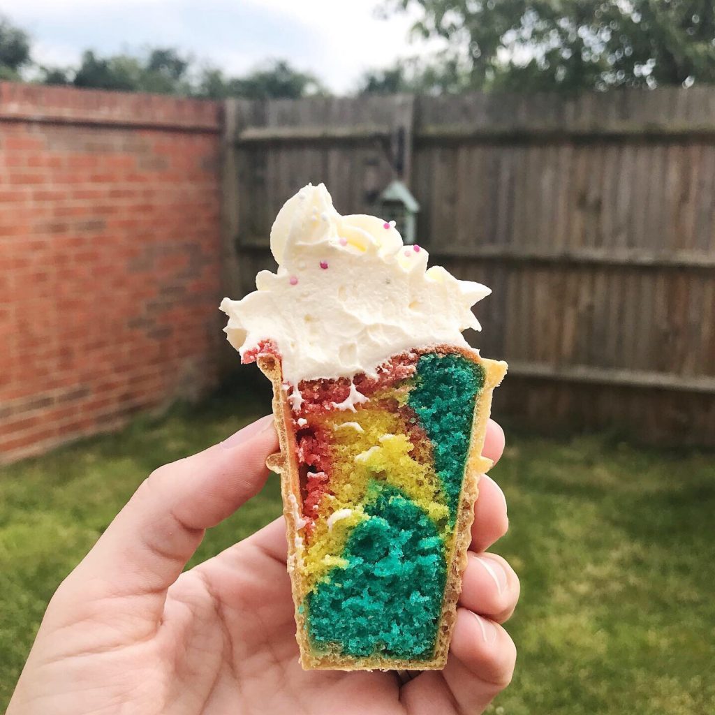 rainbow ice cream cupcakes cut in half so you can see the colours